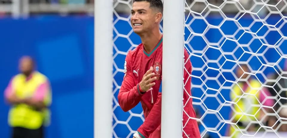 Cristiano Ronaldo celebrating behind the goal net