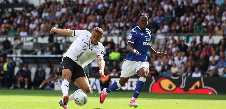Jugador de Derby County disparando hacia la portería