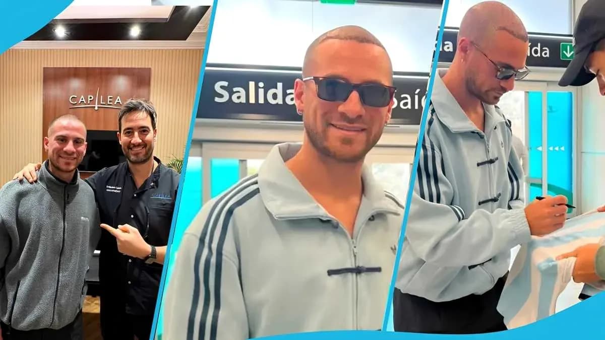 Dos hombres posando en un establecimiento y un tercero firmando autógrafo