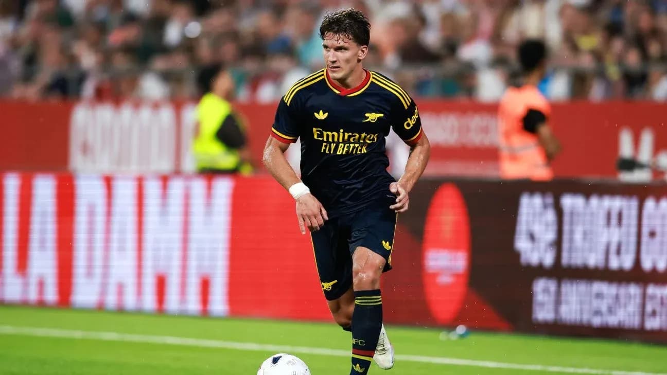 Jugador de Arsenal corriendo con el balón en campo