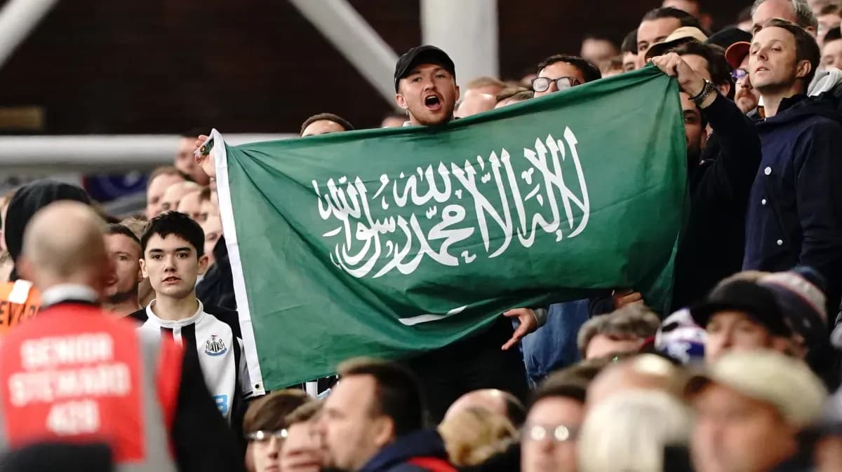 Afanático sosteniendo una bandera de Arabia Saudita en el estadio