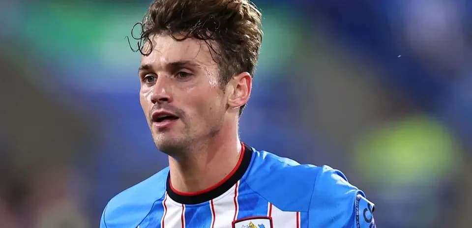 Jugador de fútbol con camiseta azul y blanca