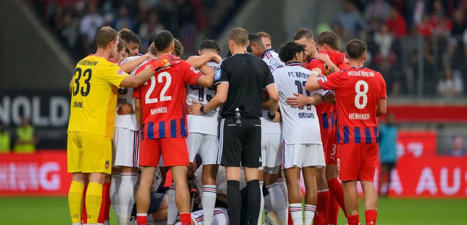 Jugadores de ambos equipos en reunión durante partido