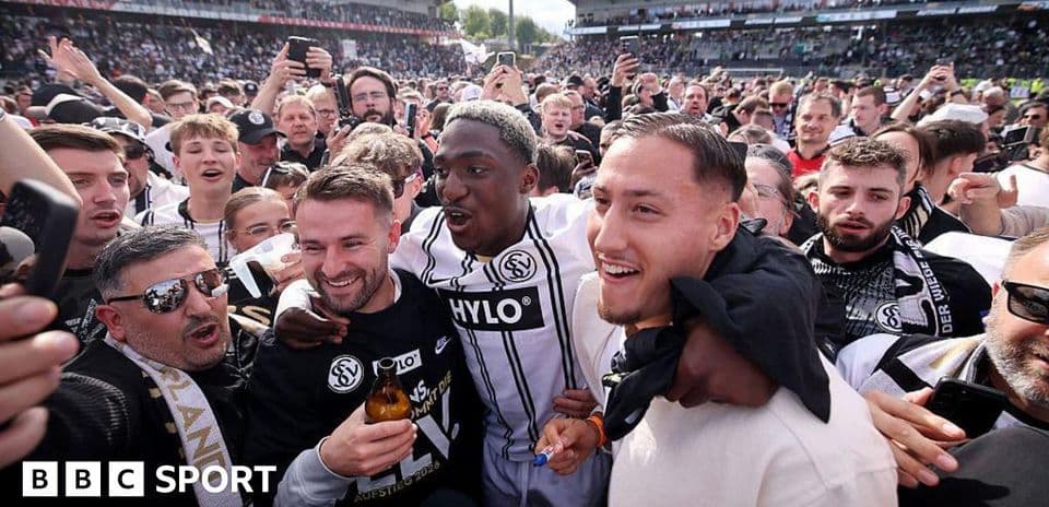 Agroup of fans celebrating with players after a match