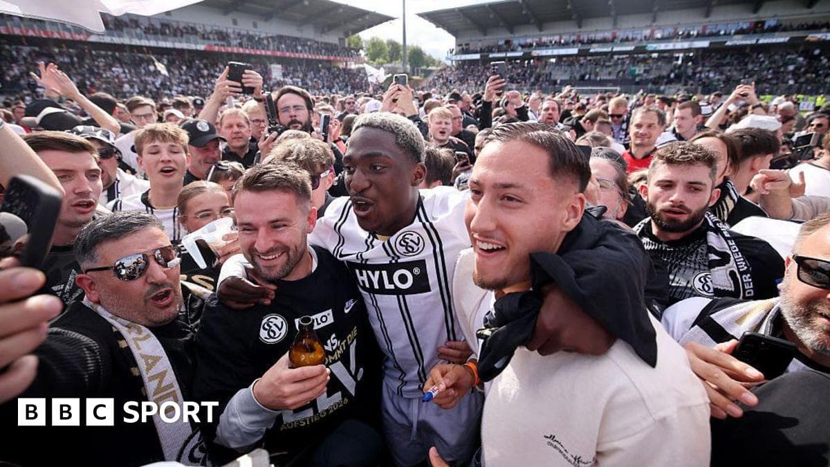 Agroup of fans celebrating with players after a match