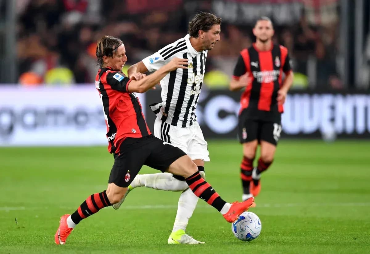 Jugador de AC Milan intentando recuperar el balón a Juventus