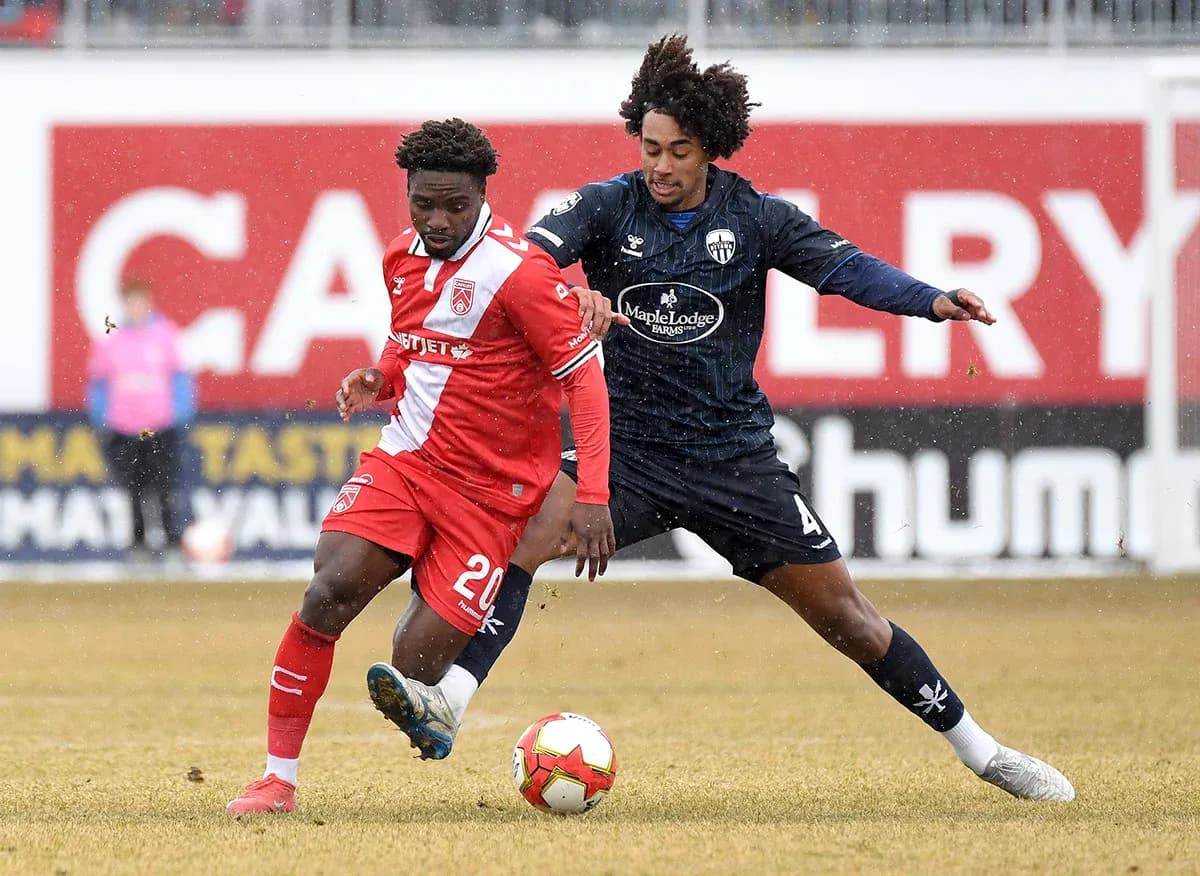 Jugadores de Atlético Ottawa y Cavalry FC en acción