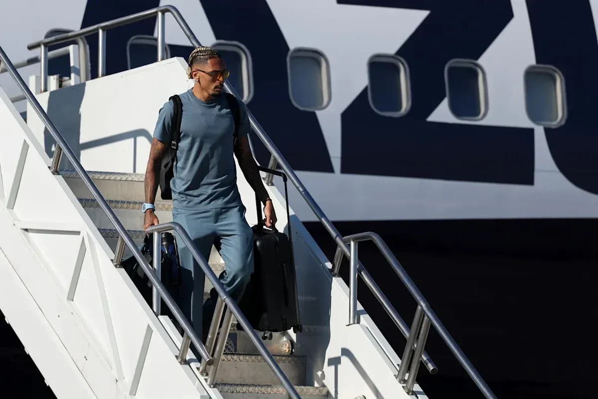 Jugador saliendo del avión con maleta