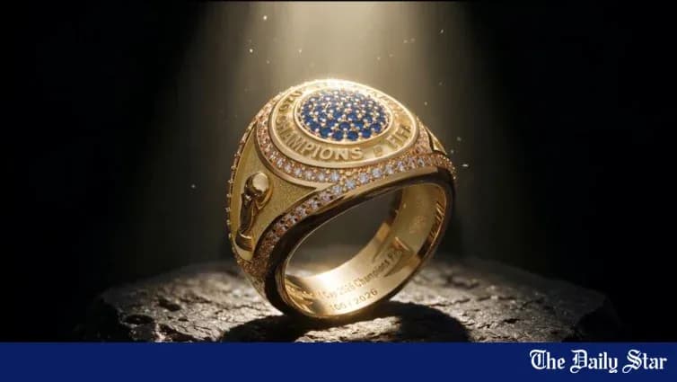 An ornate championship ring on a dark surface