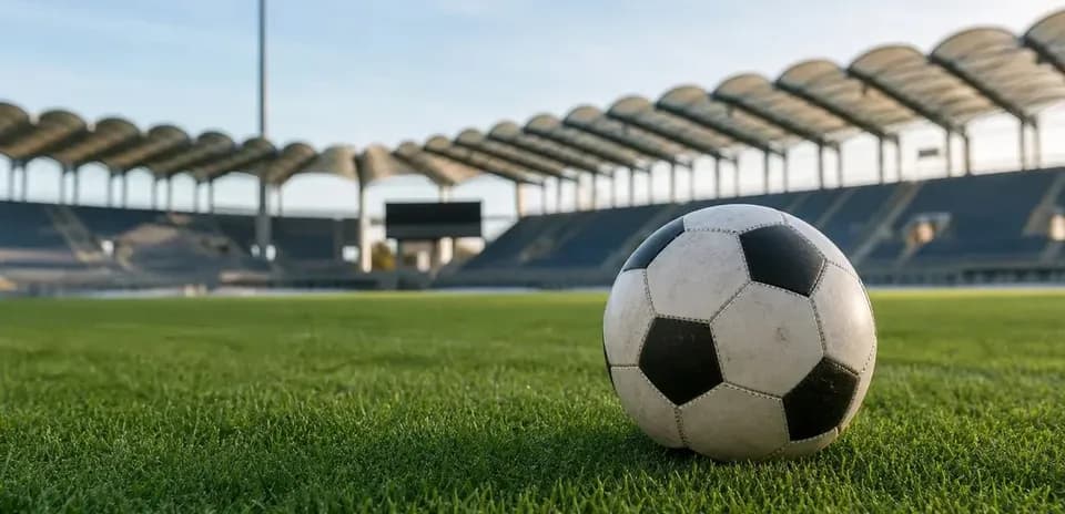 Balón de fútbol en campo de estadio vacío
