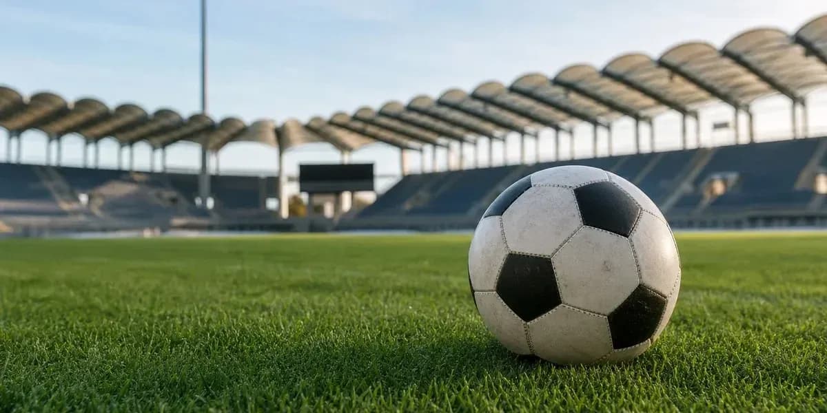 Balón de fútbol en campo de estadio vacío