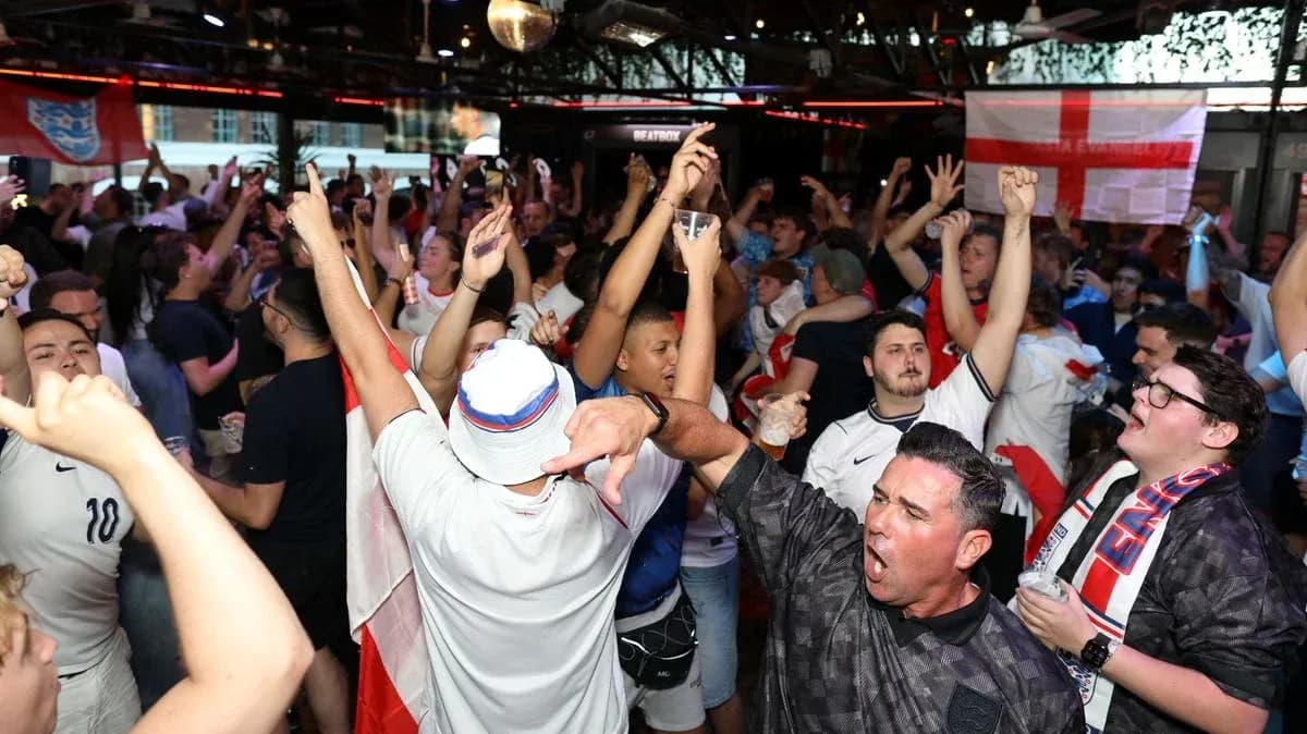 A crowd of fans celebrating in a bar