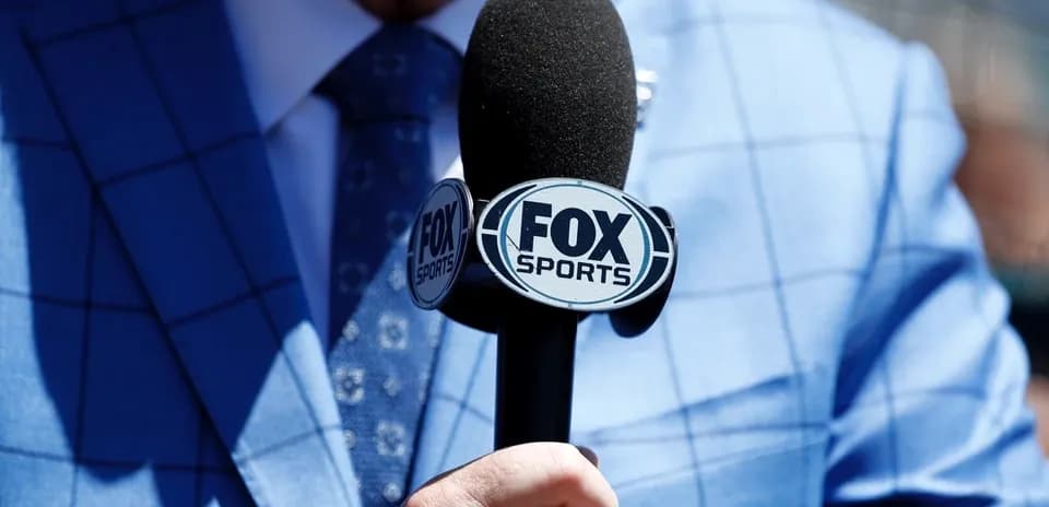 Mic with FOX Sports logo held by person