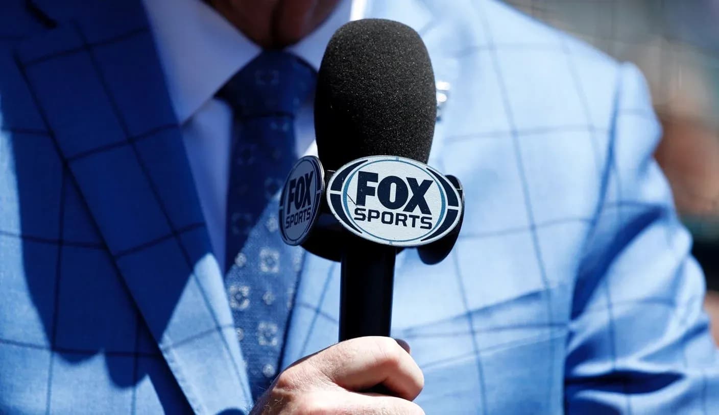 Mic with FOX Sports logo held by person