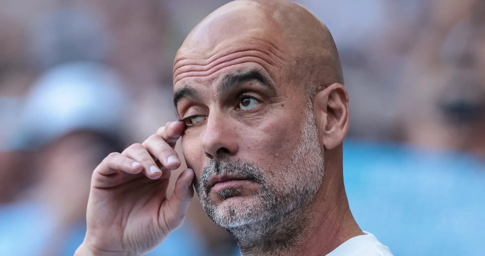 Entrenador tocándose el ojo en el banquillo