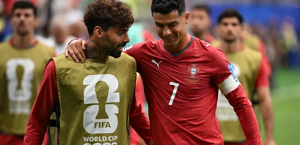 Cristiano Ronaldo conversing with teammate on field
