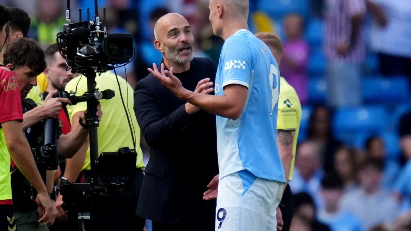 Entrenador conversando con jugador en el campo