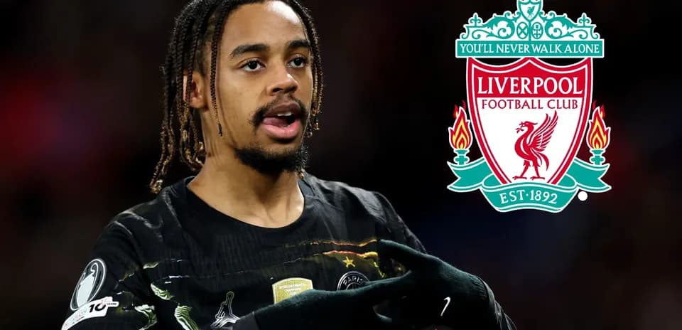 Jugador celebrando con el logo de Liverpool de fondo