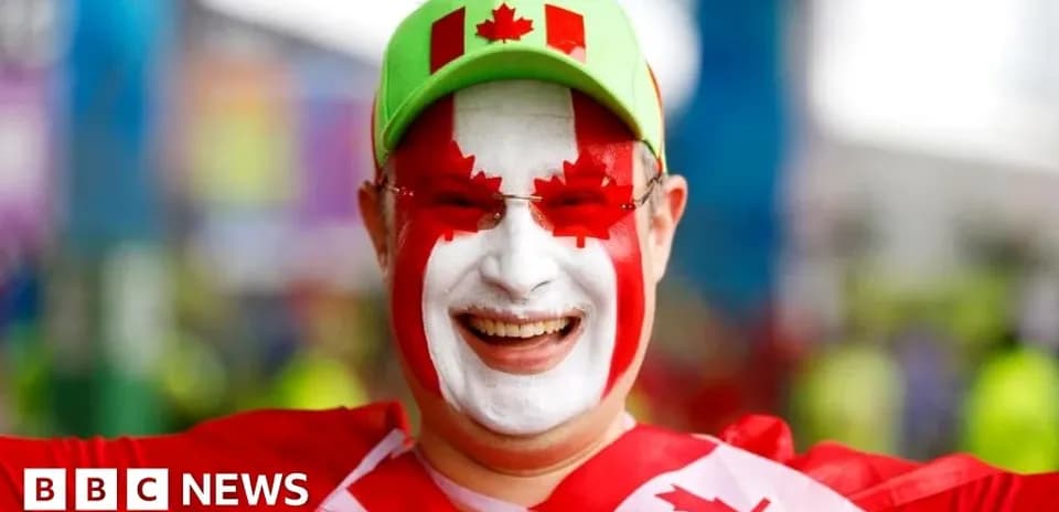 Hombre con cara pintada y gorra de Canadá sonriente