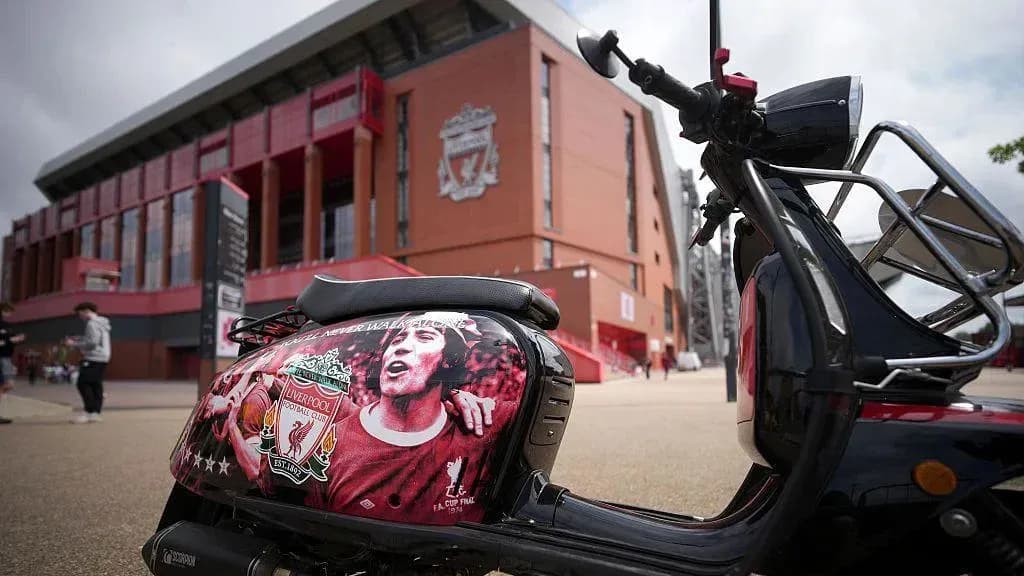 Scooter decorated with Liverpool FC logo outside stadium