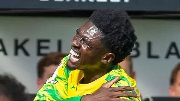 Jugador celebrando con uniforme amarillo y verde