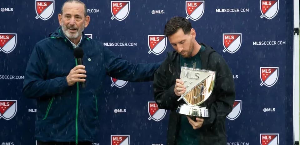 Lionel Messi holding trophy during MLS presentation