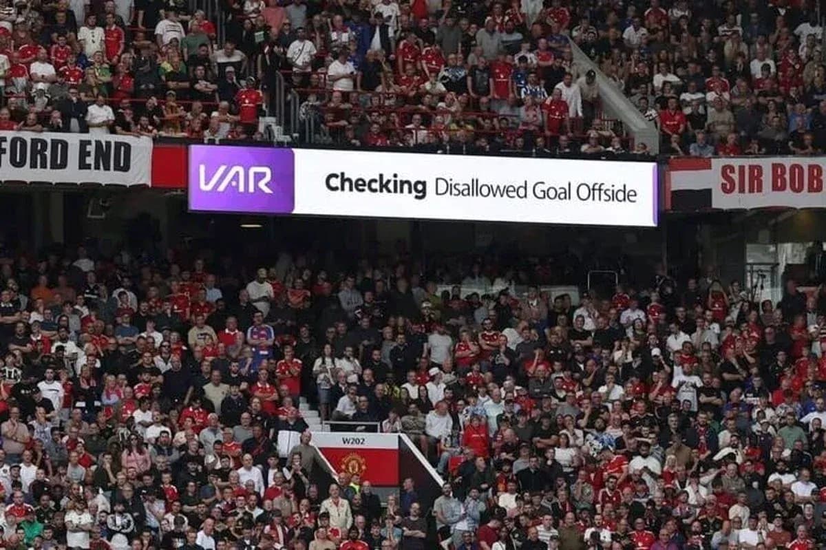 A crowd watching VAR decision on disallowed goal