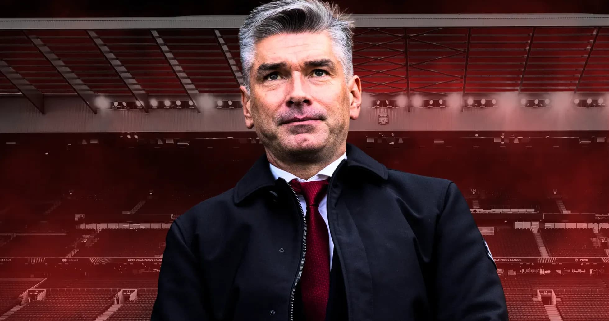 Entrenador posando en estadio con fondo oscuro