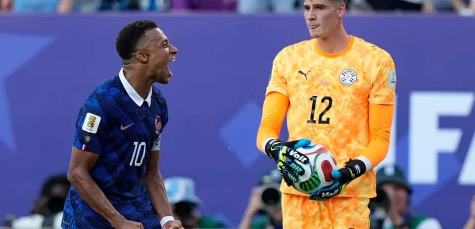 Jugador francés celebrando mientras portero paraguayo sostiene balón