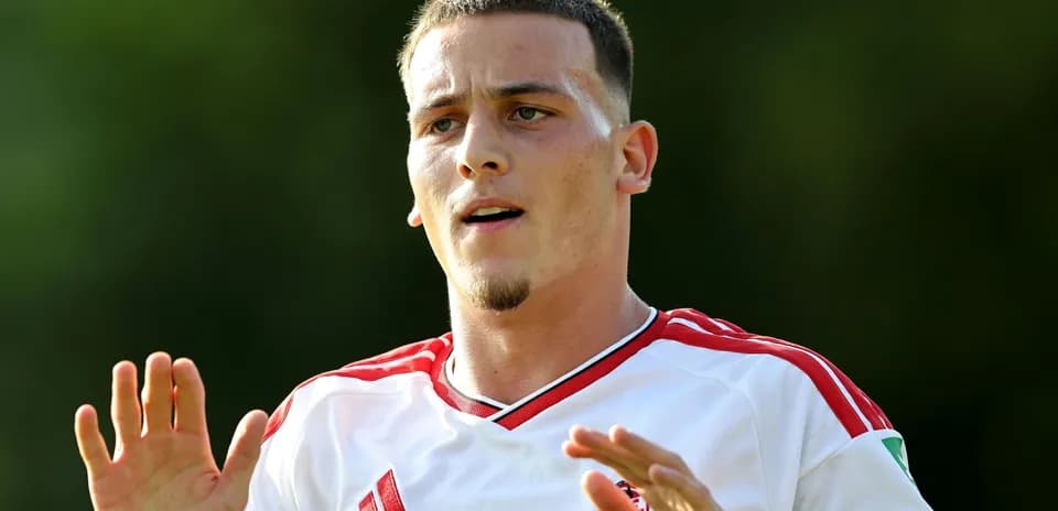 Jugador con camiseta blanca y roja en el campo