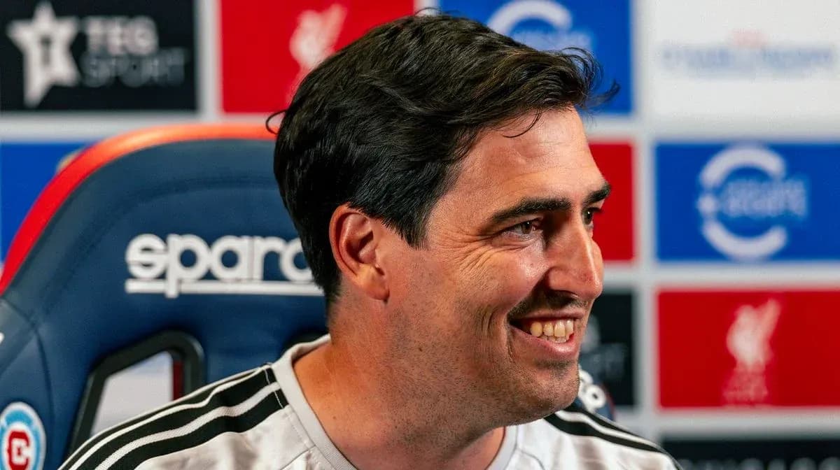 Entrenador sonriente en rueda de prensa