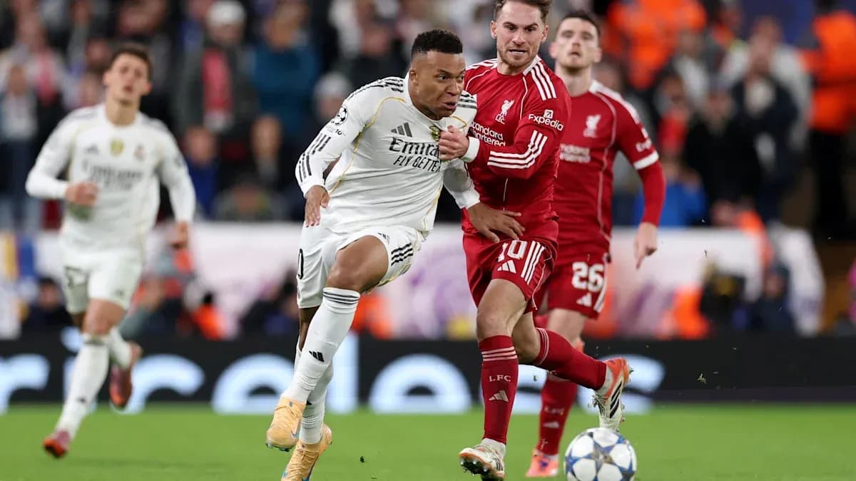 Mbappé dribbling past Liverpool players during match Mbappé dribbling past Liverpool players during match